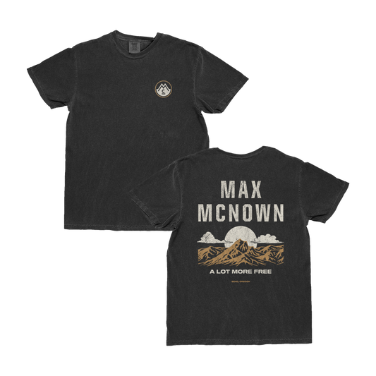 Black tee with front logo, back features mountain and sky landscape with text that reads "Max McNown"