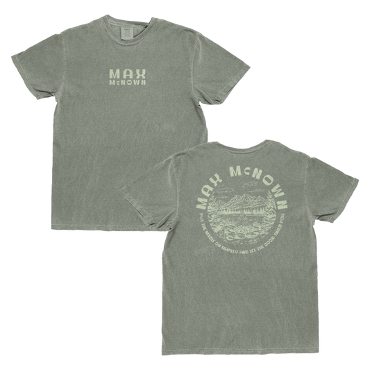 Green tee featuring nature landscape design on the back and text that reads "Max McNown Put The Needle On The Marley And Let The Good Times Roll" and front text that reads "Max McNown"